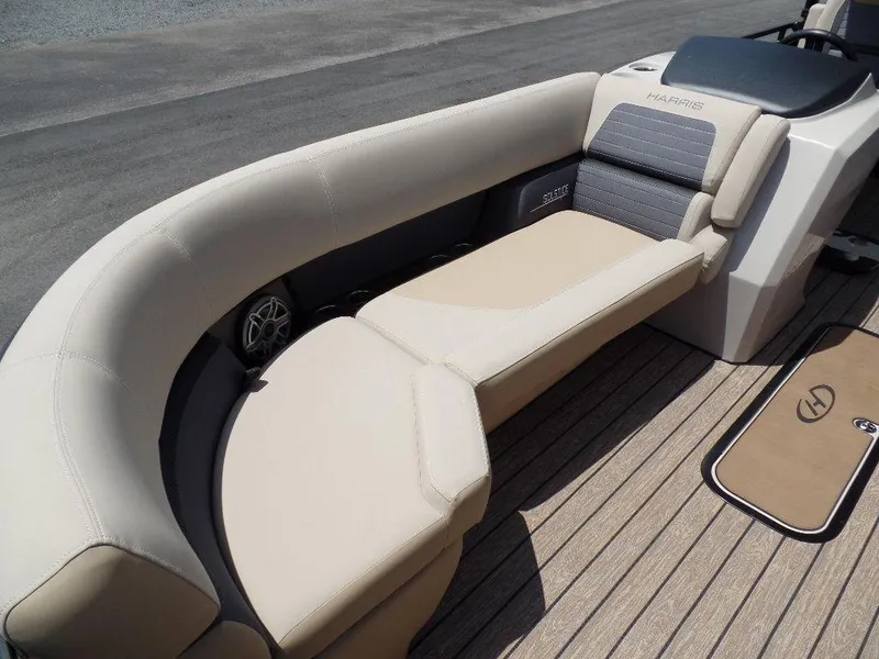 Slide: The Image of 2025 Harris Solstice 270 REC boat interior with beige seating and wood flooring. - 4