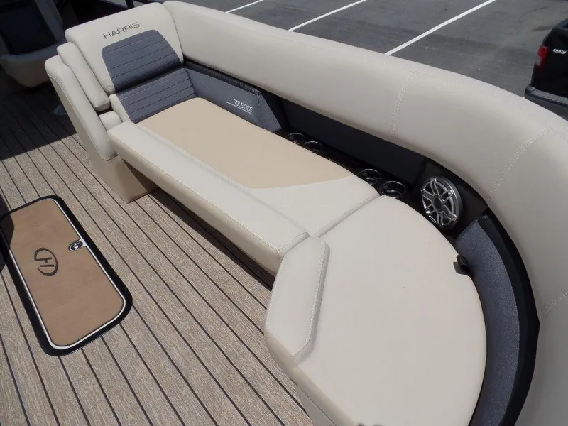 Slide: The Image of 2025 Harris Solstice 270 REC boat interior with beige seating and wood flooring. - 5