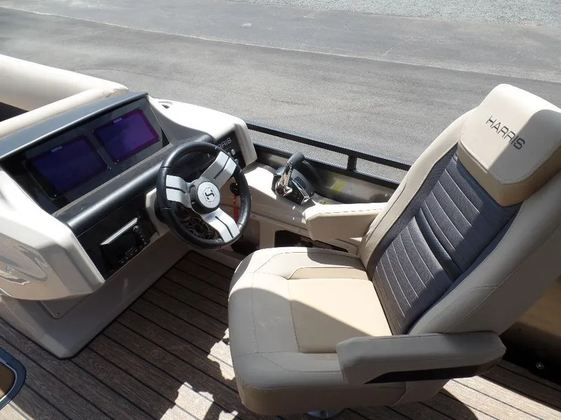 Slide: The Image of 2025 Harris Solstice 270 REC boat interior with steering wheel and captain's chair. - 7