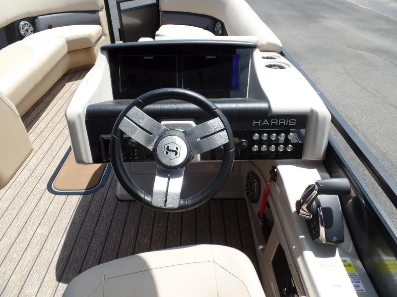 Slide: The Image of 2025 Harris Solstice 270 REC boat dashboard with steering wheel and controls. - 9
