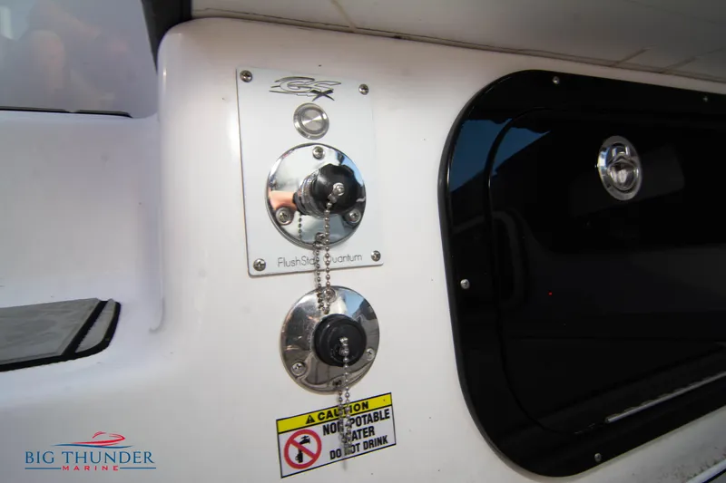 Slide: The Image of 2024 Glasstream 32 GSX boat detail with caution label and flush system. - 11