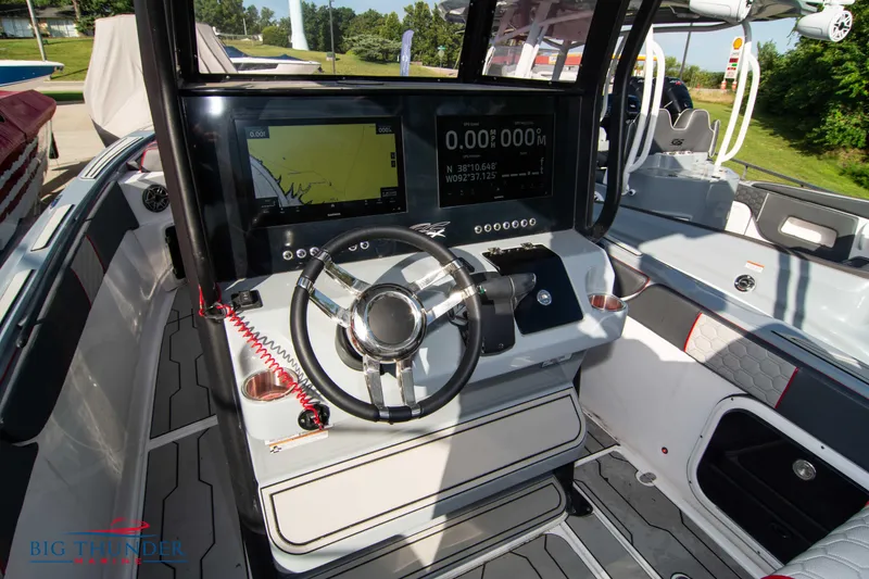 Slide: The Image of 2024 Glasstream 32 GSX boat dashboard with modern navigation system and steering wheel. - 26