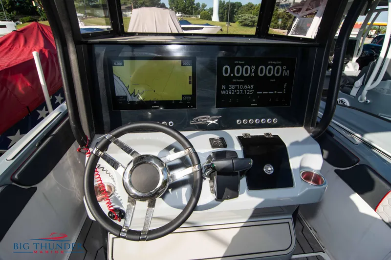 Slide: The Image of 2024 Glasstream 32 GSX boat dashboard with modern navigation displays and steering wheel. - 27