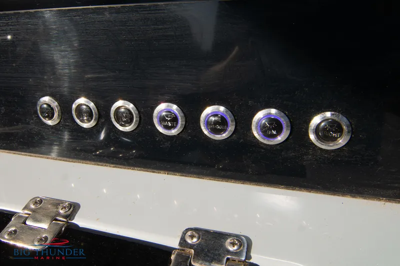 Slide: The Image of 2024 Glasstream 32 GSX dashboard buttons and controls close-up. - 31