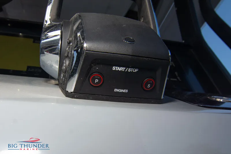 Slide: The Image of Close-up of 2024 Glasstream 32 GSX engine start/stop controls. - 36
