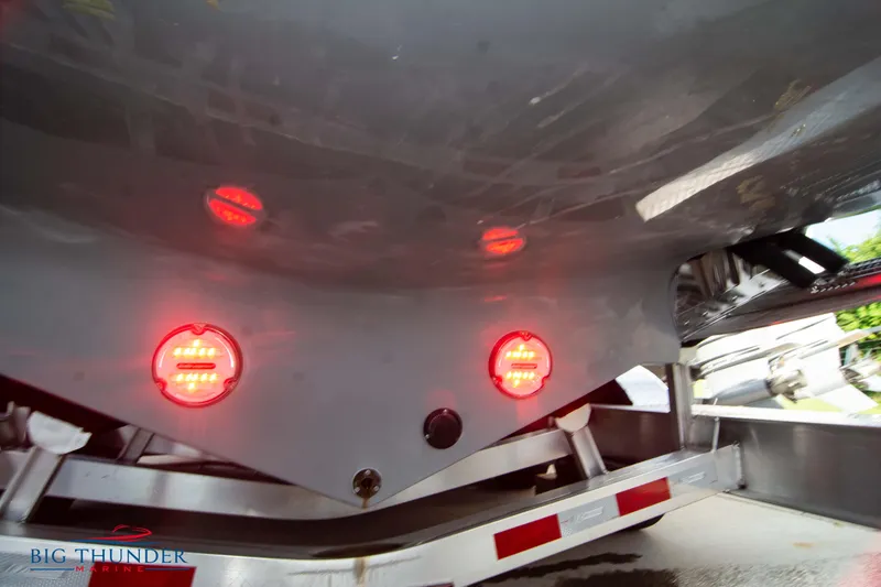 Slide: The Image of 2024 Glasstream 32 GSX boat trailer with red lights and Big Thunder logo. - 5