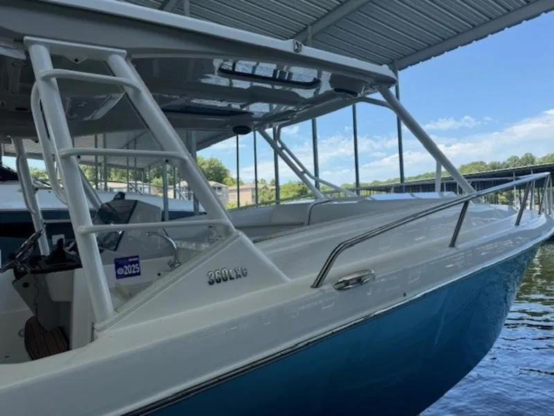 Slide: The Image of 2016 Everglades 360LXC boat docked under a covered marina. - 10