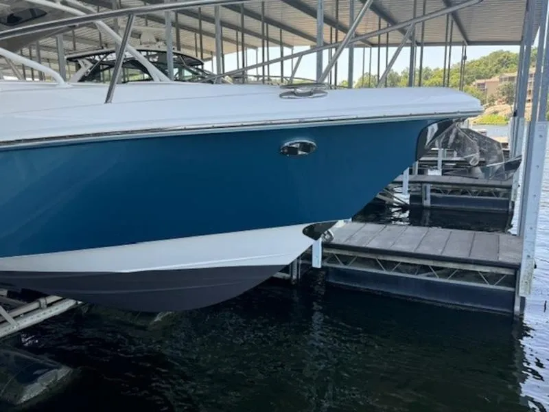 Slide: The Image of 2016 Everglades 360LXC boat docked in a marina. - 14