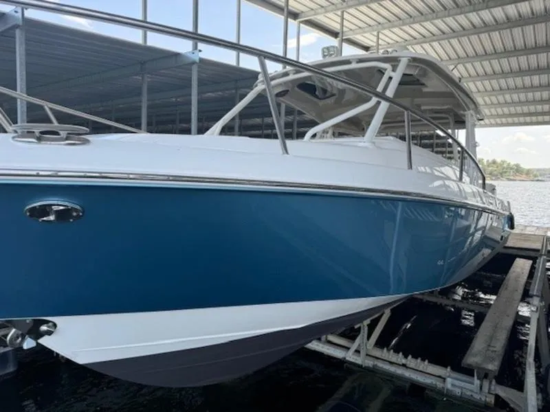 Slide: The Image of 2016 Everglades 360LXC boat docked under a covered marina. - 15