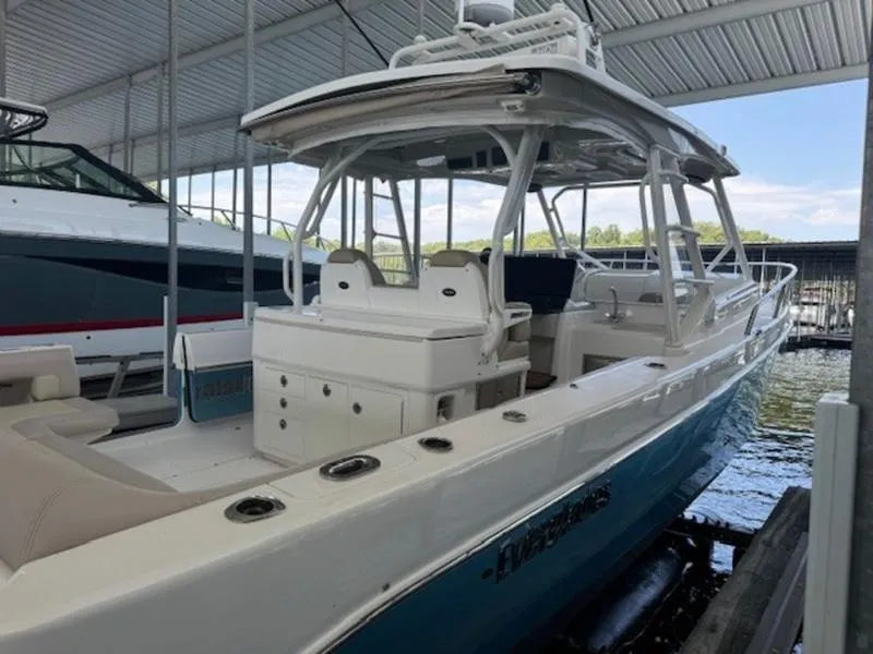 Slide: The Image of 2016 Everglades 360LXC boat docked under a covered marina. - 23