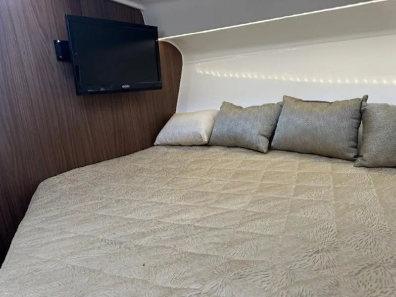 Slide: The Image of Cozy cabin interior of 2016 Everglades 360LXC with bed and mounted TV. - 31