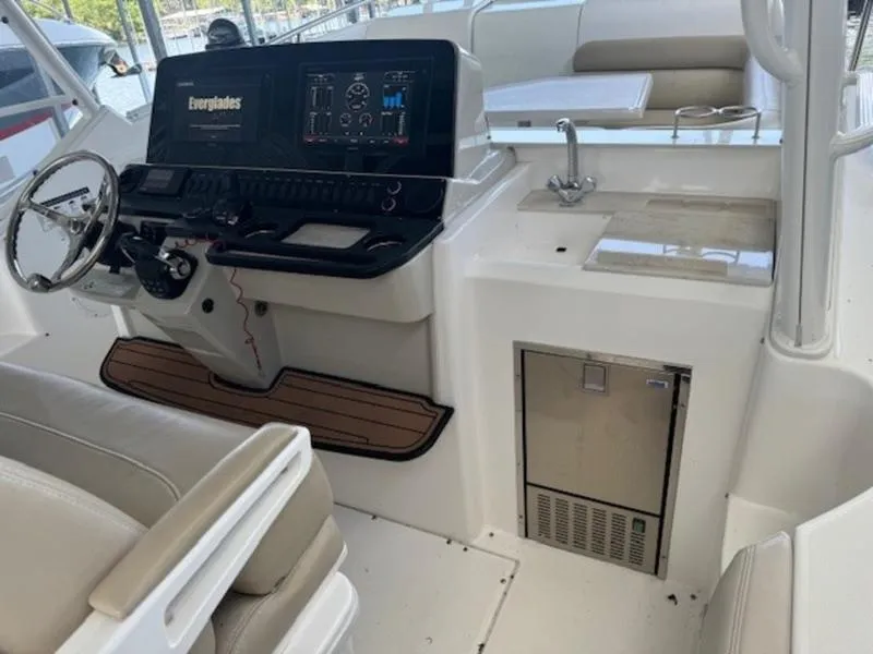 Slide: The Image of 2016 Everglades 360LXC boat interior with helm, seating, and sink. - 32