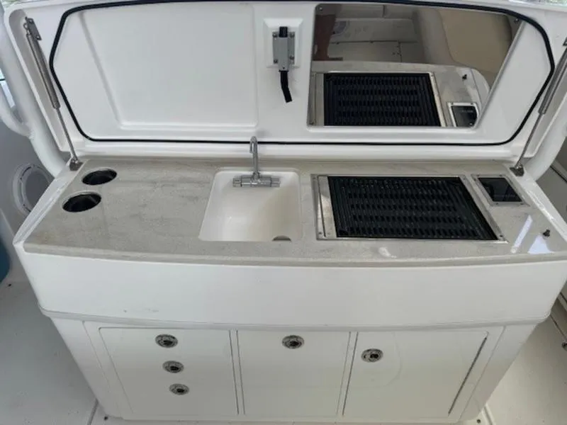 Slide: The Image of 2016 Everglades 360LXC boat kitchenette with sink and grill. - 36