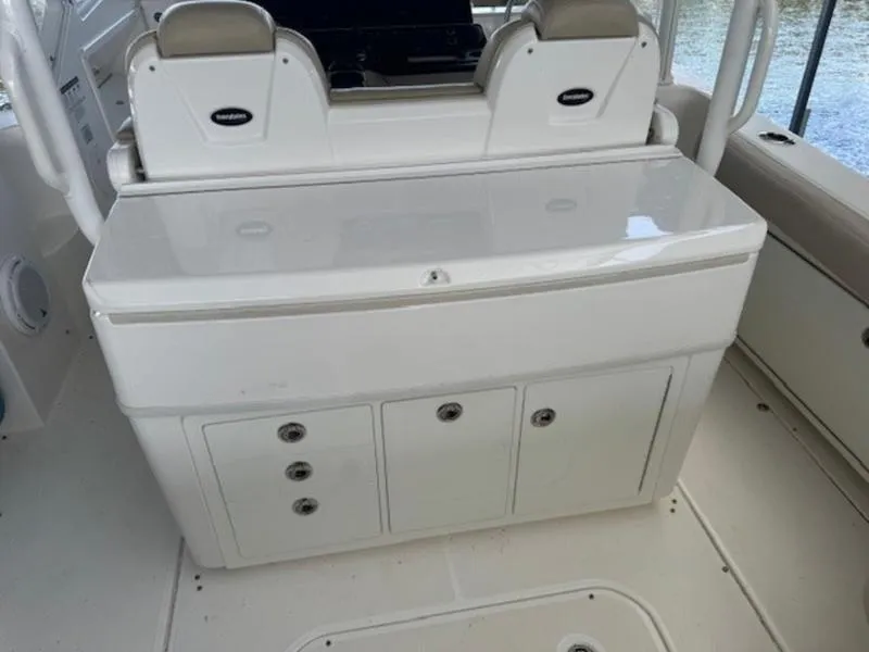 Slide: The Image of 2016 Everglades 360LXC boat interior with storage compartments and seating. - 37