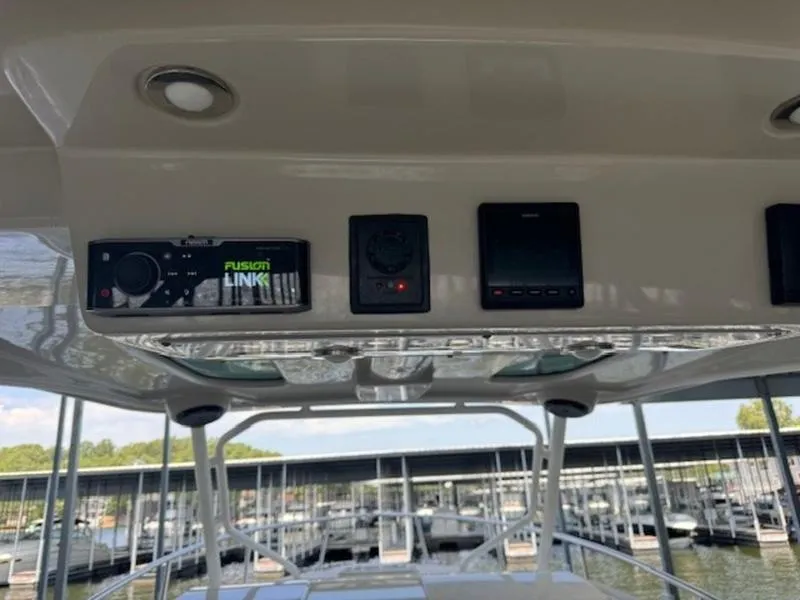 Slide: The Image of 2016 Everglades 360LXC boat dashboard with electronic controls and marina view. - 41