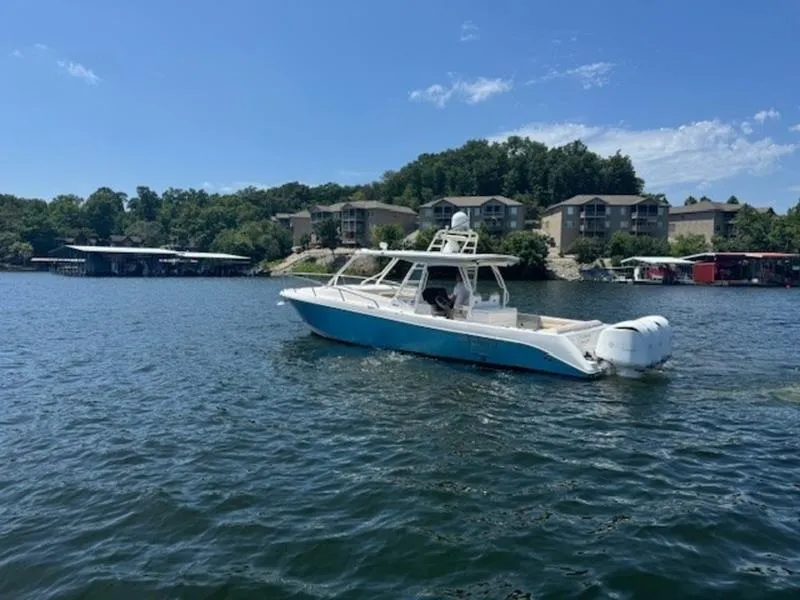 Slide: The Image of 2016 Everglades 360LXC boat on a scenic lake with waterfront homes. - 42