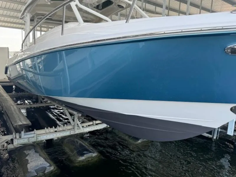 Slide: The Image of 2016 Everglades 360LXC boat in dry dock, blue hull, sleek design. - 44