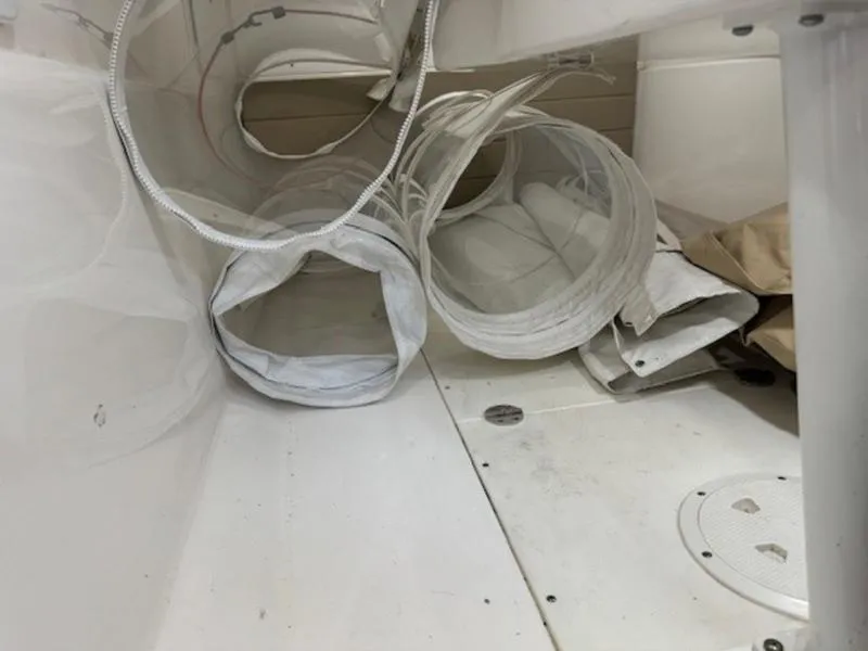 Slide: The Image of Coiled hoses and equipment inside a 2016 Everglades 360LXC boat. - 5