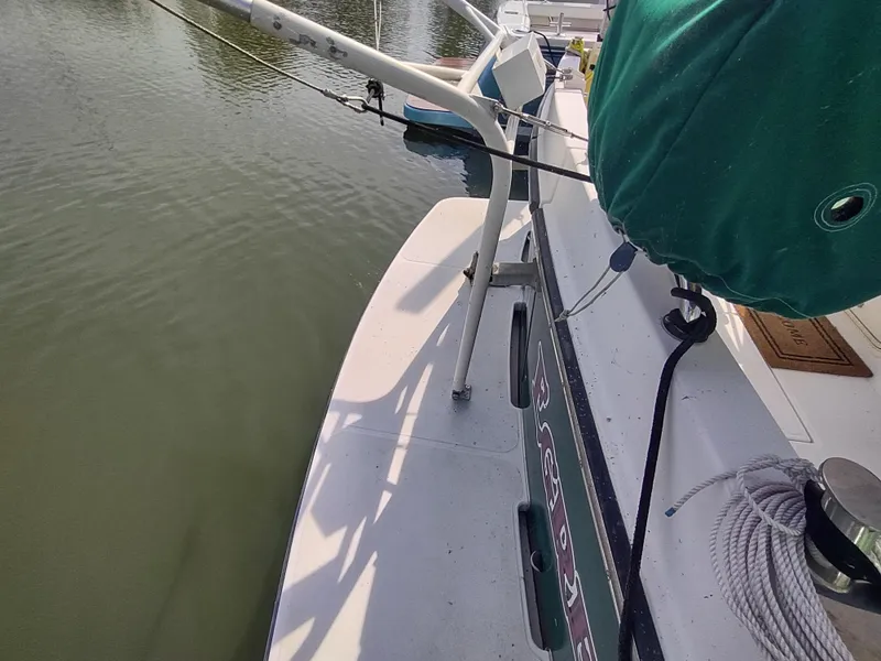 Slide: The Image of 2003 American Tug 34 boat deck with ropes and equipment by the water. - 13