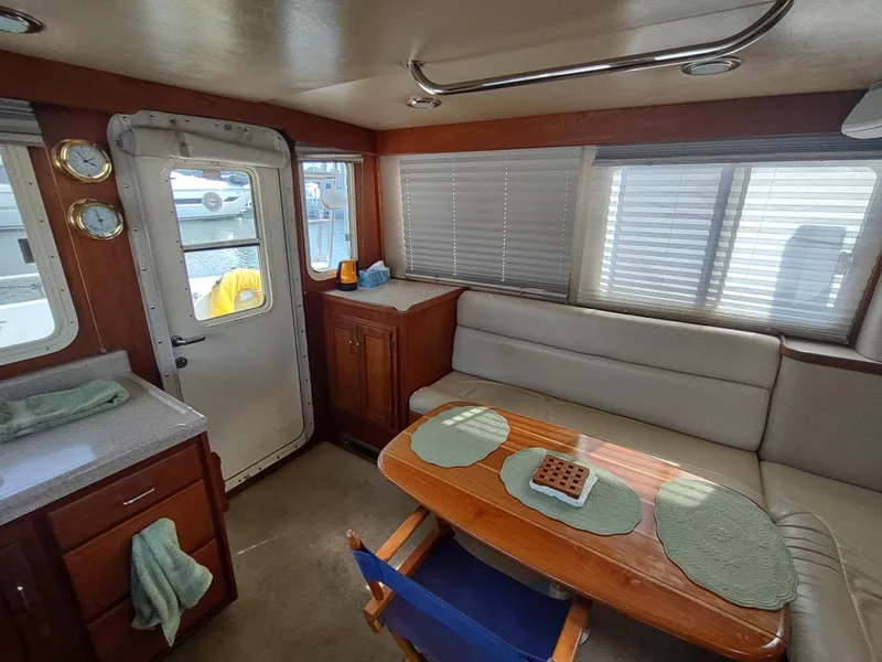 Slide: The Image of Interior of 2003 American Tug 34 with cozy seating and dining area. - 18