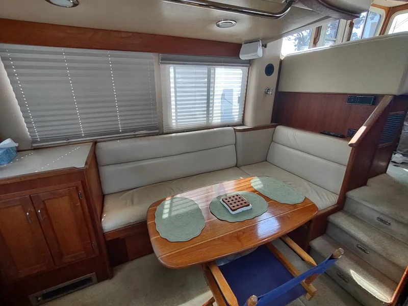Slide: The Image of Interior of 2003 American Tug 34 with cozy seating and wooden table. - 19