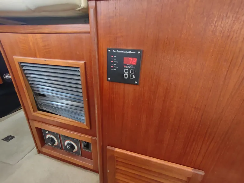 Slide: The Image of Control panel and wooden cabinetry inside a 2003 American Tug 34 boat. - 21