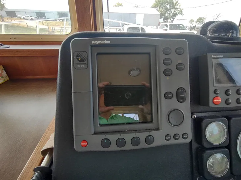 Slide: The Image of Raymarine navigation system on 2003 American Tug 34 boat dashboard. - 27