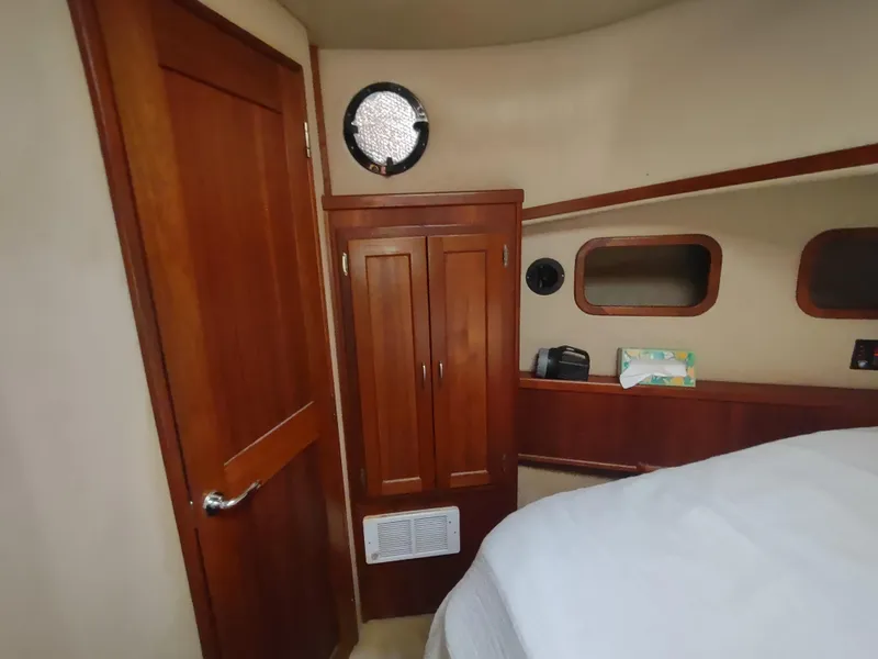 Slide: The Image of Cozy cabin interior of 2003 American Tug 34 with wooden cabinetry and porthole window. - 43