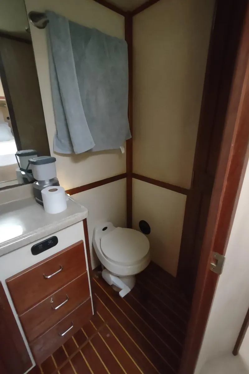 Slide: The Image of Bathroom in 2003 American Tug 34 with wooden flooring and compact amenities. - 44