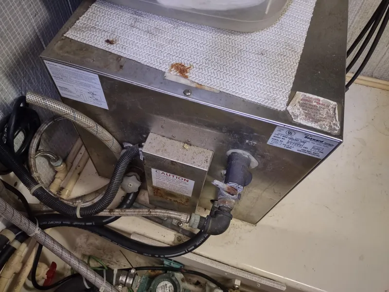 Slide: The Image of Engine compartment of a 2003 American Tug 34 with visible wiring and components. - 46