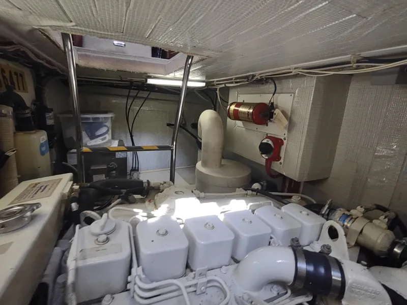Slide: The Image of Engine room of a 2003 American Tug 34, showcasing mechanical components and equipment. - 49