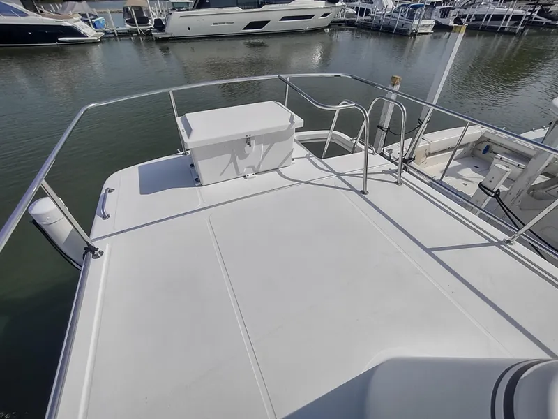 Slide: The Image of 2003 American Tug 34 boat deck with railing, docked at marina. - 7