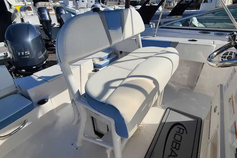 Slide: The Image of 2024 Robalo R180 Center Console boat interior with cushioned seating and Yamaha 115 engine. - 4