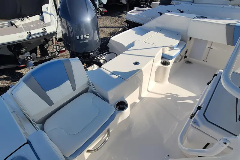 Slide: The Image of 2024 Robalo R180 Center Console boat interior with seating and Yamaha 115 engine. - 5