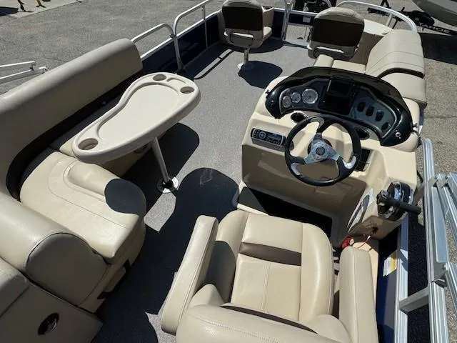 Slide: The Image of 2017 Sun Tracker Fishin' Barge 22 DLX interior with seating and steering console. - 10