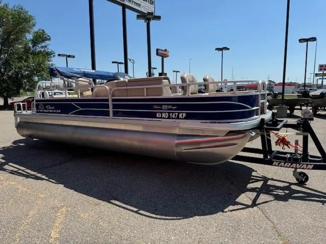 Slide: The Image of 2017 Sun Tracker Fishin' Barge 22 DLX pontoon boat on trailer in parking lot. - 5