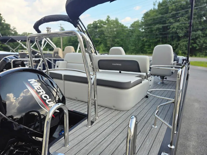 Slide: The Image of 2025 Harris Cruiser 230 boat interior with Mercury engine, featuring comfortable seating and sleek design. - 5