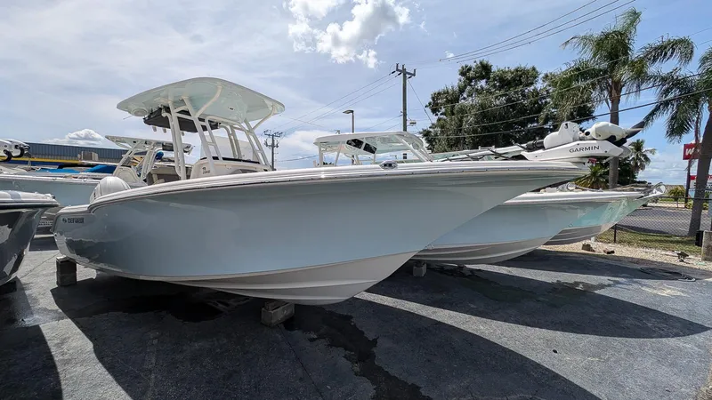 The Image of 2025 Key West 244 Center Console boat displayed outdoors on a sunny day. - 0