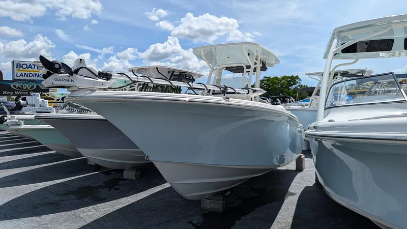 Slide: The Image of 2025 Key West 244 Center Console boats displayed at a marina under a clear blue sky. - 1