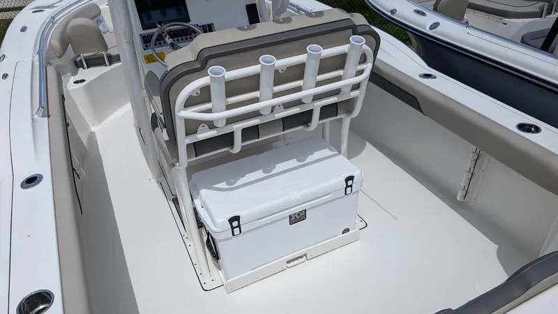 Slide: The Image of 2025 Key West 244 Center Console boat interior with rod holders and cooler. - 10