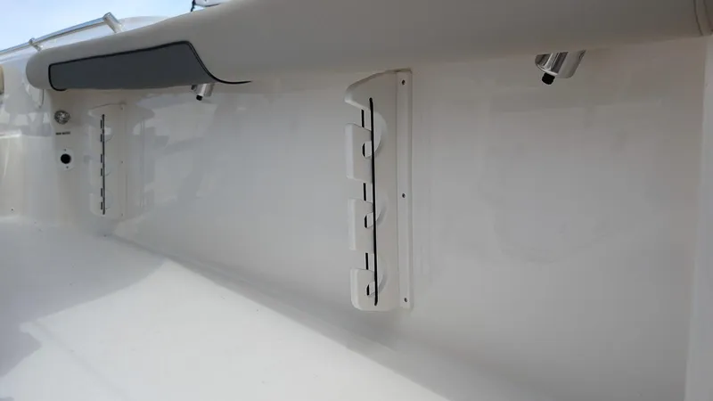 Slide: The Image of 2025 Key West 244 Center Console boat interior detail with rod holders. - 11
