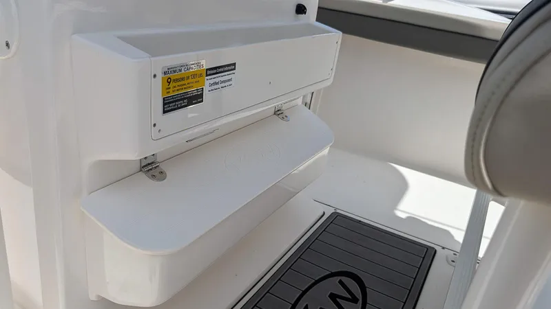 Slide: The Image of 2025 Key West 244 Center Console interior detail with storage compartment and mat. - 15