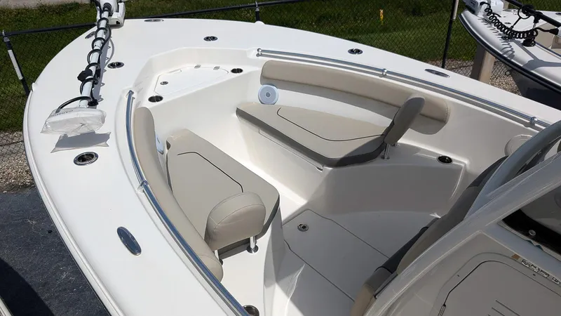 Slide: The Image of 2025 Key West 244 Center Console boat interior with beige seating and sleek design. - 17