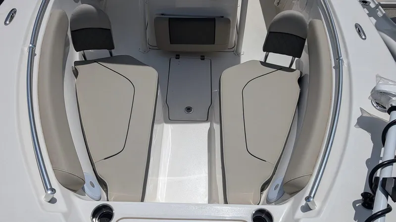 Slide: The Image of 2025 Key West 244 Center Console boat interior with beige seating and modern design. - 18