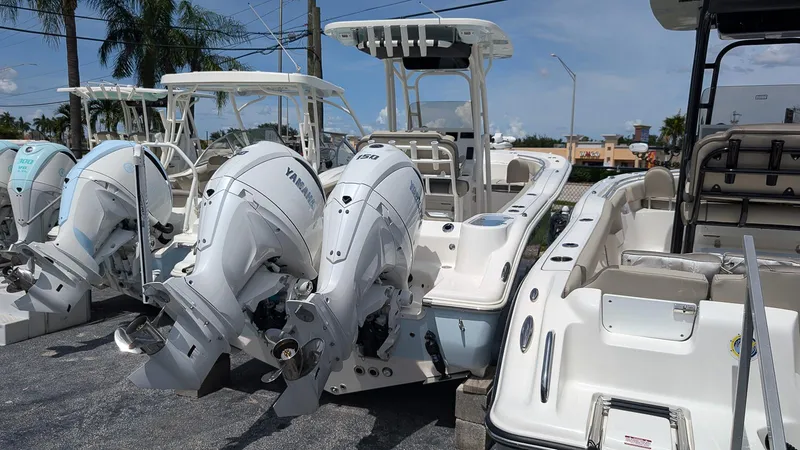 Slide: The Image of 2025 Key West 244 Center Console boats with Yamaha outboard engines, parked outdoors. - 3