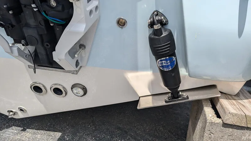Slide: The Image of Close-up of 2025 Key West 244 Center Console boat's trim tab and engine components. - 4