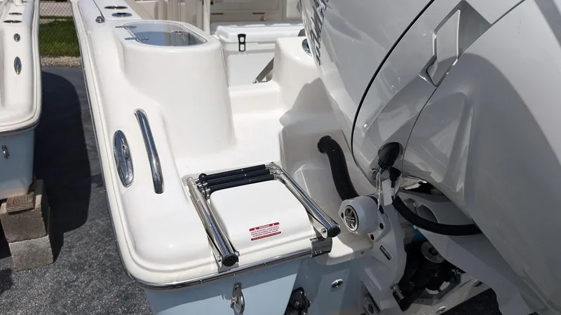 Slide: The Image of 2025 Key West 244 Center Console boat with outboard motor and swim ladder. - 5
