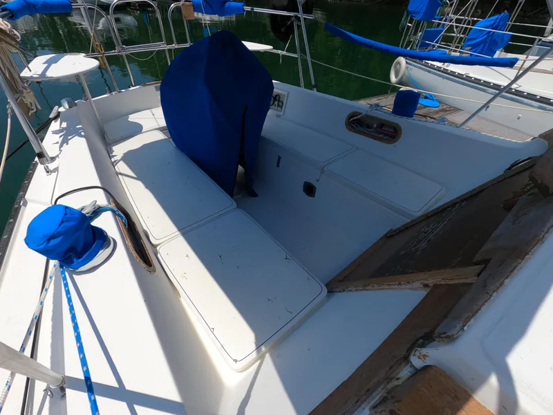 Slide: The Image of 1985 Catalina 30 sailboat cockpit with blue covers and seating. - 10