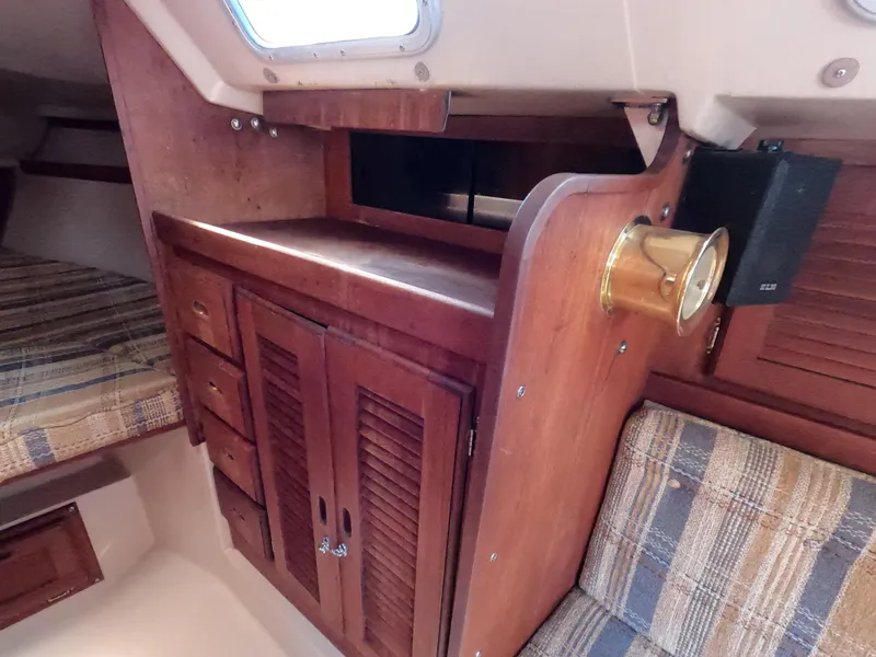Slide: The Image of Interior of 1985 Catalina 30 sailboat with wooden cabinetry and plaid upholstery. - 18