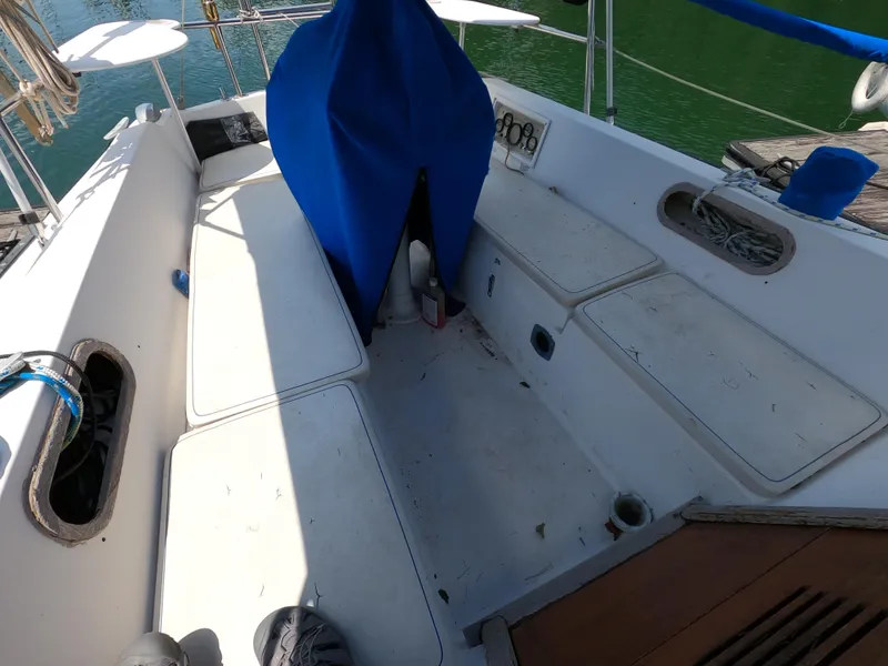 Slide: The Image of Cockpit of 1985 Catalina 30 sailboat with white seating and blue cover. - 6